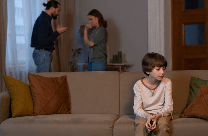child suffering from abuse by parents fighting at home